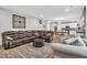 Open-concept living room and kitchen area, featuring hardwood floors and modern decor at 6350 Lantana Village Way, Cumming, GA 30028