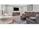 Spacious living room with hardwood floors, a large TV, and comfortable seating at 6350 Lantana Village Way, Cumming, GA 30028