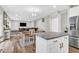 Open floor plan with dining area adjacent to a spacious living room with stainless steel refrigerator at 6350 Lantana Village Way, Cumming, GA 30028
