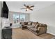 Comfortable room with plush sectional sofa, ceiling fan, and a view to outside at 6350 Lantana Village Way, Cumming, GA 30028