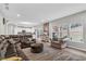 Open-concept living room with kitchen view, showcasing modern furniture and natural light at 6350 Lantana Village Way, Cumming, GA 30028
