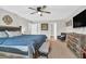 Spacious main bedroom featuring a ceiling fan, a picture over the bed and mounted television at 6350 Lantana Village Way, Cumming, GA 30028