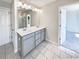 Well-lit bathroom featuring double sinks and a large mirror at 7109 Gladstone Cir, Lithonia, GA 30038