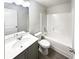 Clean bathroom featuring a large mirror, vanity with ample storage, and a shower-tub combo at 7109 Gladstone Cir, Lithonia, GA 30038