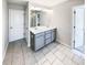 Well-lit bathroom featuring double sinks and a large mirror at 7109 Gladstone Cir, Lithonia, GA 30038