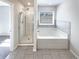 Bright bathroom with a separate shower and tub at 7109 Gladstone Cir, Lithonia, GA 30038
