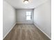 Cozy bedroom with neutral carpet and natural light from the window at 7109 Gladstone Cir, Lithonia, GA 30038