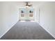 Spacious bedroom with gray carpet, ceiling fan, and natural light at 7109 Gladstone Cir, Lithonia, GA 30038