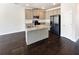 Modern kitchen boasts stainless appliances, granite counters, ample cabinet space, and a kitchen island at 7109 Gladstone Cir, Lithonia, GA 30038