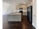 Well-equipped kitchen with island, granite counters, stainless steel appliances, and dark hardwood floors at 7109 Gladstone Cir, Lithonia, GA 30038