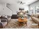 Bright, open-concept living room with stylish furnishings, ceiling fan, and abundant natural light at 7109 Gladstone Cir, Lithonia, GA 30038