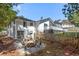 Landscaped backyard with a fire pit area, and a large 2 story home at 1025 Martins Lake Close, Roswell, GA 30076