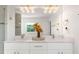 Bright bathroom featuring a double vanity with marble countertops and modern lighting fixtures at 1025 Martins Lake Close, Roswell, GA 30076