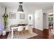 Inviting dining room with modern decor, white chairs, wood table, and hardwood flooring at 1025 Martins Lake Close, Roswell, GA 30076