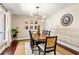Elegant dining room featuring hardwood floors, a modern light fixture, and a large window at 1025 Martins Lake Close, Roswell, GA 30076