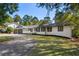 Lovely single-story home showcasing a gray and white color scheme, with mature trees at 1025 Martins Lake Close, Roswell, GA 30076
