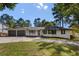 Charming ranch home featuring a well-manicured lawn and a two-car garage at 1025 Martins Lake Close, Roswell, GA 30076
