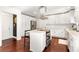 Spacious kitchen features white cabinets, stainless steel appliances, kitchen island, and hardwood floors at 1025 Martins Lake Close, Roswell, GA 30076