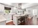 Bright kitchen with white cabinets and stainless steel appliances, and a breakfast bar with seating at 1025 Martins Lake Close, Roswell, GA 30076