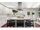 Bright kitchen with white cabinets, stainless steel hood, a kitchen island, and dark hardwood floors at 1025 Martins Lake Close, Roswell, GA 30076