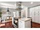 Open kitchen with stainless steel appliances, a kitchen island, and easy access to the dining area at 1025 Martins Lake Close, Roswell, GA 30076