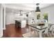 Bright kitchen with white cabinets and stainless steel appliances, opens up to a dining area and backyard at 1025 Martins Lake Close, Roswell, GA 30076
