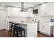 Bright kitchen with white cabinets and stainless steel appliances, and a breakfast bar with seating at 1025 Martins Lake Close, Roswell, GA 30076