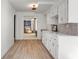 Clean kitchenette featuring white cabinets, stone backsplash, and an open layout at 1025 Martins Lake Close, Roswell, GA 30076