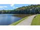 Scenic view of the lake, with a paved walking path and park bench, ideal for peaceful strolls and enjoying nature at 1025 Martins Lake Close, Roswell, GA 30076
