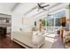 Bright and airy living room featuring a white sofa, hardwood floors, and large windows to a deck at 1025 Martins Lake Close, Roswell, GA 30076