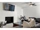 Bright living room showcasing a painted brick fireplace, ceiling fan and comfortable couch at 1025 Martins Lake Close, Roswell, GA 30076
