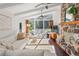 Bright living room features a stone fireplace, white sofa, hardwood floors, and large windows to a deck at 1025 Martins Lake Close, Roswell, GA 30076