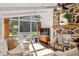 Bright living room features a stone fireplace, white sofa, hardwood floors, and large windows to a deck at 1025 Martins Lake Close, Roswell, GA 30076