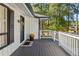 Welcoming front porch with white railings and a charming entrance with black door at 1025 Martins Lake Close, Roswell, GA 30076