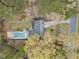 Aerial view of a property featuring a home with a pool and lush landscaping, highlighting the property's layout at 1303 Bass Dr, Woodstock, GA 30189