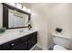 Bathroom featuring black and white tile, dark vanity, and modern fixtures at 1303 Bass Dr, Woodstock, GA 30189
