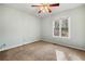 Bedroom featuring a window and neutral carpet and a ceiling fan at 1303 Bass Dr, Woodstock, GA 30189