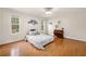 Bedroom featuring hardwood floors, natural light, and a decorative accent wall at 1303 Bass Dr, Woodstock, GA 30189