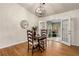 Dining area with French doors leading to a sunroom and a modern light fixture at 1303 Bass Dr, Woodstock, GA 30189