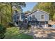Charming two-story home with a manicured lawn, a two-car garage, and a welcoming entrance at 1303 Bass Dr, Woodstock, GA 30189