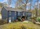 Rear exterior of a two-story blue home showing back yard, patio and upper level deck area at 1303 Bass Dr, Woodstock, GA 30189