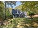 Charming two-story home with a well-maintained lawn, three-car garage, and inviting front entrance at 1303 Bass Dr, Woodstock, GA 30189
