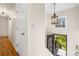 Bright hallway leading to a staircase, with a decorative light fixture and view of the outside at 1303 Bass Dr, Woodstock, GA 30189