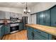 Kitchen with stainless steel appliances, two-tone cabinets, a center island, and hardwood floors at 1303 Bass Dr, Woodstock, GA 30189