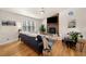 Cozy living room with a stone fireplace, hardwood floors, and ample natural light at 1303 Bass Dr, Woodstock, GA 30189