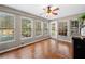Bright sunroom with hardwood floors, lots of windows, and a view of the outdoor pool at 1303 Bass Dr, Woodstock, GA 30189