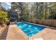 Inviting blue swimming pool with surrounding patio, landscaping, and a view of the home at 1303 Bass Dr, Woodstock, GA 30189