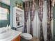 Bathroom with a patterned shower curtain, built in shelves, and window at 170 Cobblestone Ct, Douglasville, GA 30134