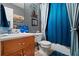 Bathroom featuring modern fixtures, a tile floor, and a blue shower curtain at 170 Cobblestone Ct, Douglasville, GA 30134