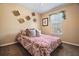 Bedroom with neutral walls, a patterned bedspread, and a bright window at 170 Cobblestone Ct, Douglasville, GA 30134